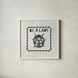 Ladybug Stamp Be A Lady by Courtney Prahl. Shown in a crisp white glass frame for a clean and minimalist style. Available as an archival giclee rolled canvas, fine art paper, or poster print. SKU 52084a.