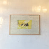 Laugh Collage by Courtney Prahl. shown as a paper print in a natural frame. Available as a archival giclee rolled canvas, fine art paper, or poster print. SKU 52562i.