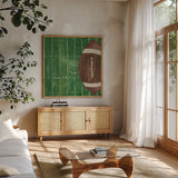 On the Field I by Courtney Prahl. Shown in a natural wood frame in a cozy modern living room. Available as an archival giclee rolled canvas, fine art paper, or poster print. SKU 31723a.