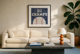 On the Field III Go Champs by Courtney Prahl. Displayed in a glass frame with matte in a clean modern living room. Available as an archival giclee rolled canvas, fine art paper, or poster print. SKU 32960a.
