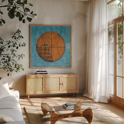Play Ball IV Blue by Courtney Prahl. Shown in a natural wood frame in a cozy modern living room. Available as an archival giclee rolled canvas, fine art paper, or poster print. SKU 63513a.
