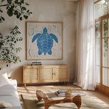 Sea Creature Turtle Blue by Courtney Prahl. Shown in a natural wood frame in a cozy modern living room. Available as an archival giclee rolled canvas, fine art paper, or poster print. SKU 21276a.