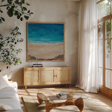 The Cove by Courtney Prahl. Shown in a natural wood frame in a cozy modern living room. Available as an archival giclee rolled canvas, fine art paper, or poster print. SKU 90055a.