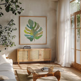 Tropical Fun Palms II by Courtney Prahl. Shown in a natural wood frame in a cozy modern living room. Available as an archival giclee rolled canvas, fine art paper, or poster print. SKU 35698a.