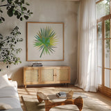 Tropical Fun Palms IIII by Courtney Prahl. Shown in a natural wood frame in a cozy modern living room. Available as an archival giclee rolled canvas, fine art paper, or poster print. SKU 35699a.