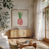 Tropical Fun Pineapple I by Courtney Prahl. Shown in a natural wood frame in a cozy modern living room. Available as an archival giclee rolled canvas, fine art paper, or poster print. SKU 35701a.
