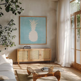 Tropical Fun Pineapple Silhouette I by Courtney Prahl. Shown in a natural wood frame in a cozy modern living room. Available as an archival giclee rolled canvas, fine art paper, or poster print. SKU 35711a.
