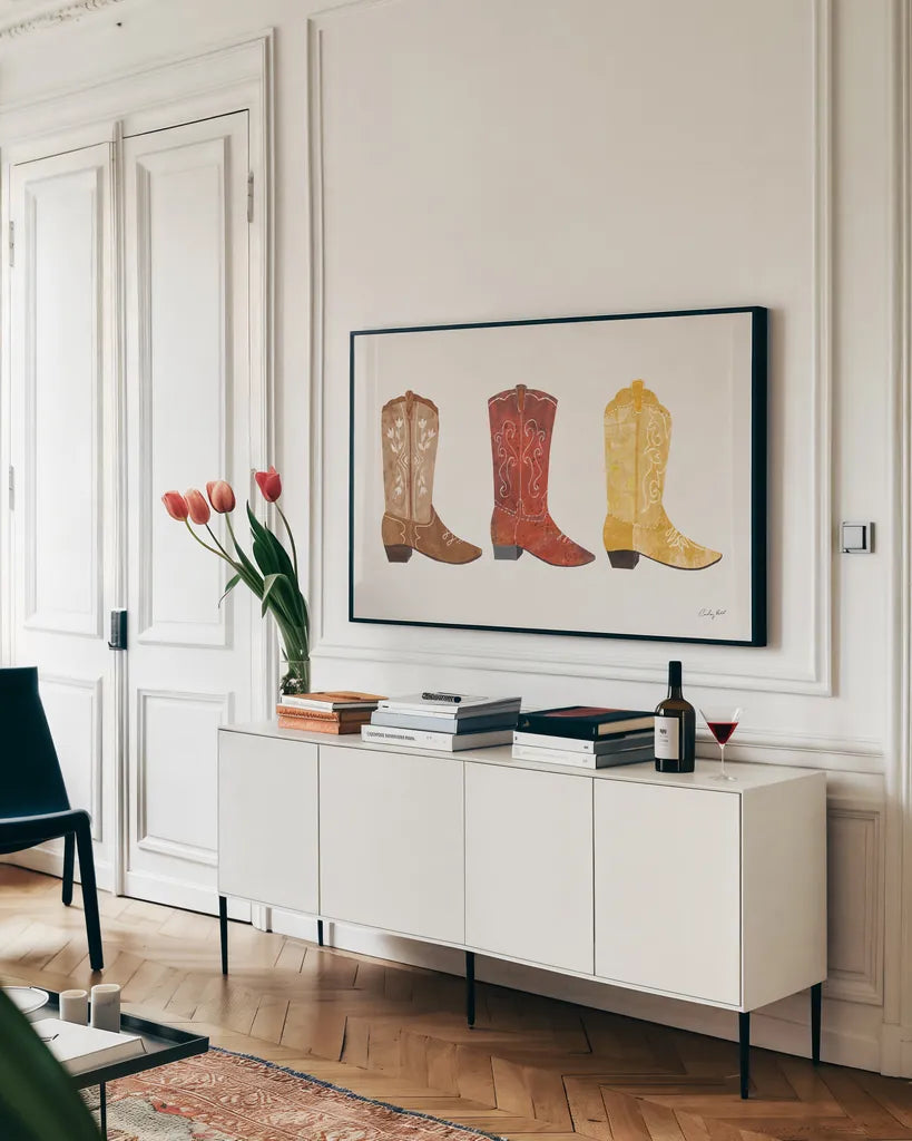 Western Cowgirl Boot VII by Courtney Prahl. shown as a framed stretched canvas in a living room above a console. Available as a archival giclee rolled canvas, fine art paper, or poster print. SKU 81379i.