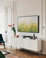 A Row of Yellow Blossoms by Danhui Nai. shown as a framed stretched canvas in a living room above a console. Available as a archival giclee rolled canvas, fine art paper, or poster print. SKU 100173i.