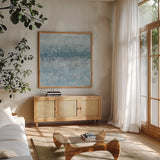 Abstract Rain Slate Blue by Danhui Nai. Shown in a natural wood frame in a cozy modern living room. Available as an archival giclee rolled canvas, fine art paper, or poster print. SKU 75527a.