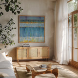 Abstract Stripes Blue by Danhui Nai. Shown in a natural wood frame in a cozy modern living room. Available as an archival giclee rolled canvas, fine art paper, or poster print. SKU 49977a.