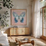 Aflutter I Watercolor by Danhui Nai. Shown in a natural wood frame in a cozy modern living room. Available as an archival giclee rolled canvas, fine art paper, or poster print. SKU 88610a.
