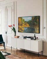 Autumn River by Danhui Nai. shown as a framed stretched canvas in a living room above a console. Available as a archival giclee rolled canvas, fine art paper, or poster print. SKU 100348i.