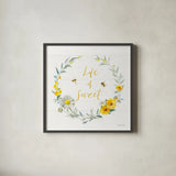 Bees and Blooms_Life is Sweet Wreath by Danhui Nai. Shown in a sleek black glass frame for a contemporary gallery look. Available as an archival giclee rolled canvas, fine art paper, or poster print. SKU 78405a.