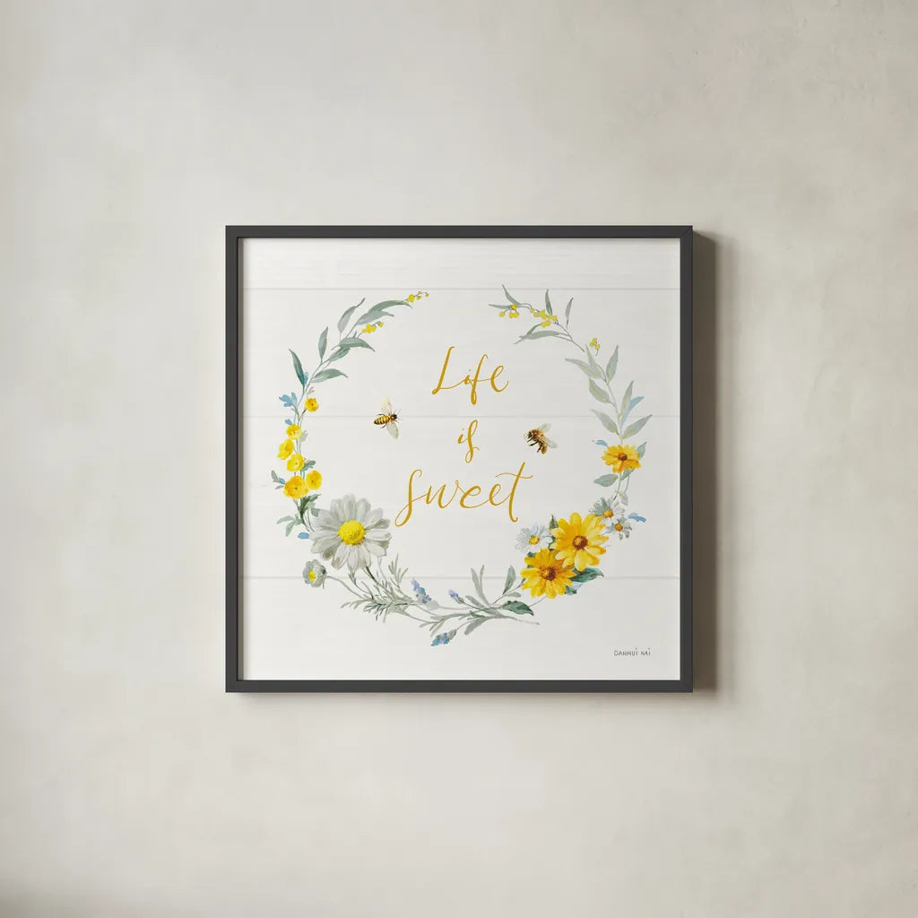 Bees and Blooms_Life is Sweet Wreath by Danhui Nai. Shown in a sleek black glass frame for a contemporary gallery look. Available as an archival giclee rolled canvas, fine art paper, or poster print. SKU 78405a.