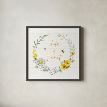 Bees and Blooms_Life is Sweet Wreath by Danhui Nai. Shown in a sleek black glass frame for a contemporary gallery look. Available as an archival giclee rolled canvas, fine art paper, or poster print. SKU 78405a.