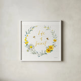 Bees and Blooms_Life is Sweet Wreath by Danhui Nai. Shown in a crisp white glass frame for a clean and minimalist style. Available as an archival giclee rolled canvas, fine art paper, or poster print. SKU 78405a.