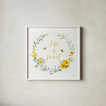 Bees and Blooms_Life is Sweet Wreath by Danhui Nai. Shown in a crisp white glass frame for a clean and minimalist style. Available as an archival giclee rolled canvas, fine art paper, or poster print. SKU 78405a.