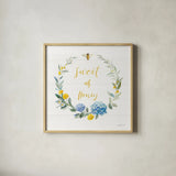 Bees and Blooms_Sweet As Honey Wreath by Danhui Nai. Shown in a natural wood glass frame for a timeless modern aesthetic. Available as an archival giclee rolled canvas, fine art paper, or poster print. SKU 78406a.