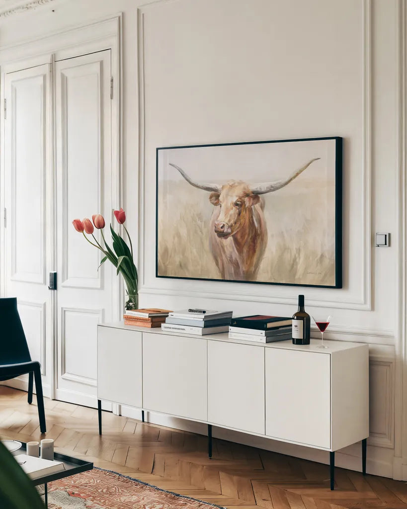 Big Sky Longhorn Neutral by Danhui Nai. shown as a framed stretched canvas in a living room above a console. Available as a archival giclee rolled canvas, fine art paper, or poster print. SKU 77169i.