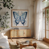 Blue Butterfly I by Danhui Nai. Shown in a natural wood frame in a cozy modern living room. Available as an archival giclee rolled canvas, fine art paper, or poster print. SKU 99152a.