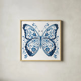 Blue Butterfly II by Danhui Nai. Shown in a natural wood glass frame for a timeless modern aesthetic. Available as an archival giclee rolled canvas, fine art paper, or poster print. SKU 99153a.