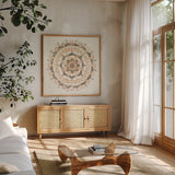 Blush Mandala by Danhui Nai. Shown in a natural wood frame in a cozy modern living room. Available as an archival giclee rolled canvas, fine art paper, or poster print. SKU 41577a.