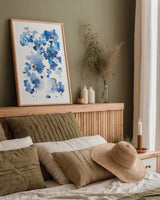 Cascading Petals I by Danhui Nai. shown as a paper print in a natural frame. Available as a archival giclee rolled canvas, fine art paper, or poster print. SKU 68221h.