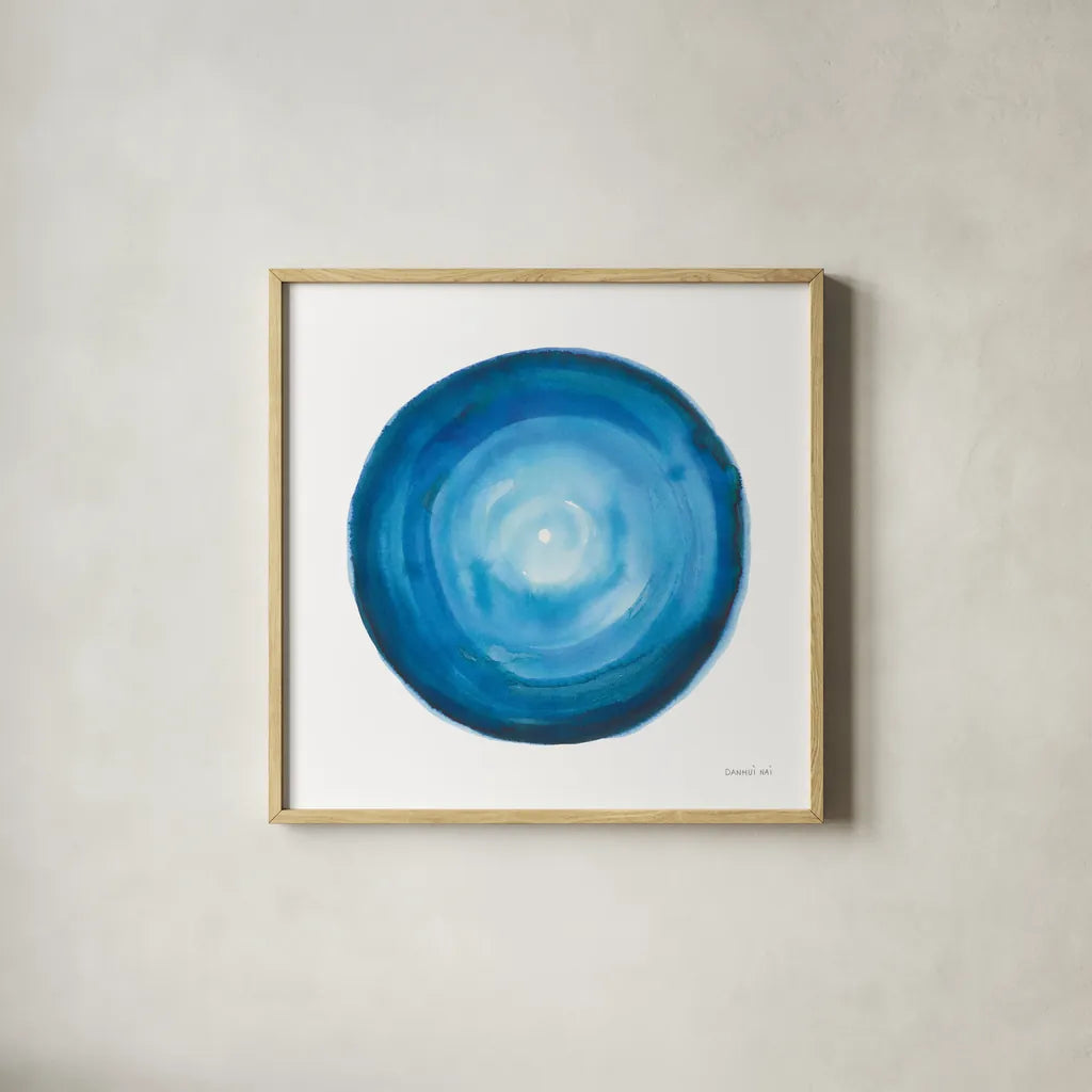 Center of Blue II by Danhui Nai. Shown in a natural wood glass frame for a timeless modern aesthetic. Available as an archival giclee rolled canvas, fine art paper, or poster print. SKU 76094a.