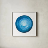Center of Blue II by Danhui Nai. Shown in a crisp white glass frame for a clean and minimalist style. Available as an archival giclee rolled canvas, fine art paper, or poster print. SKU 76094a.