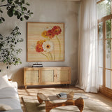 Dancing Gerberas on Stripes by Danhui Nai. Shown in a natural wood frame in a cozy modern living room. Available as an archival giclee rolled canvas, fine art paper, or poster print. SKU 1135a.