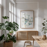 Eucalyptus III White Crop by Danhui Nai. shown as a print in a natural wood frame in a dining room. Available as a archival giclee rolled canvas, fine art paper, or poster print. SKU 35491h.