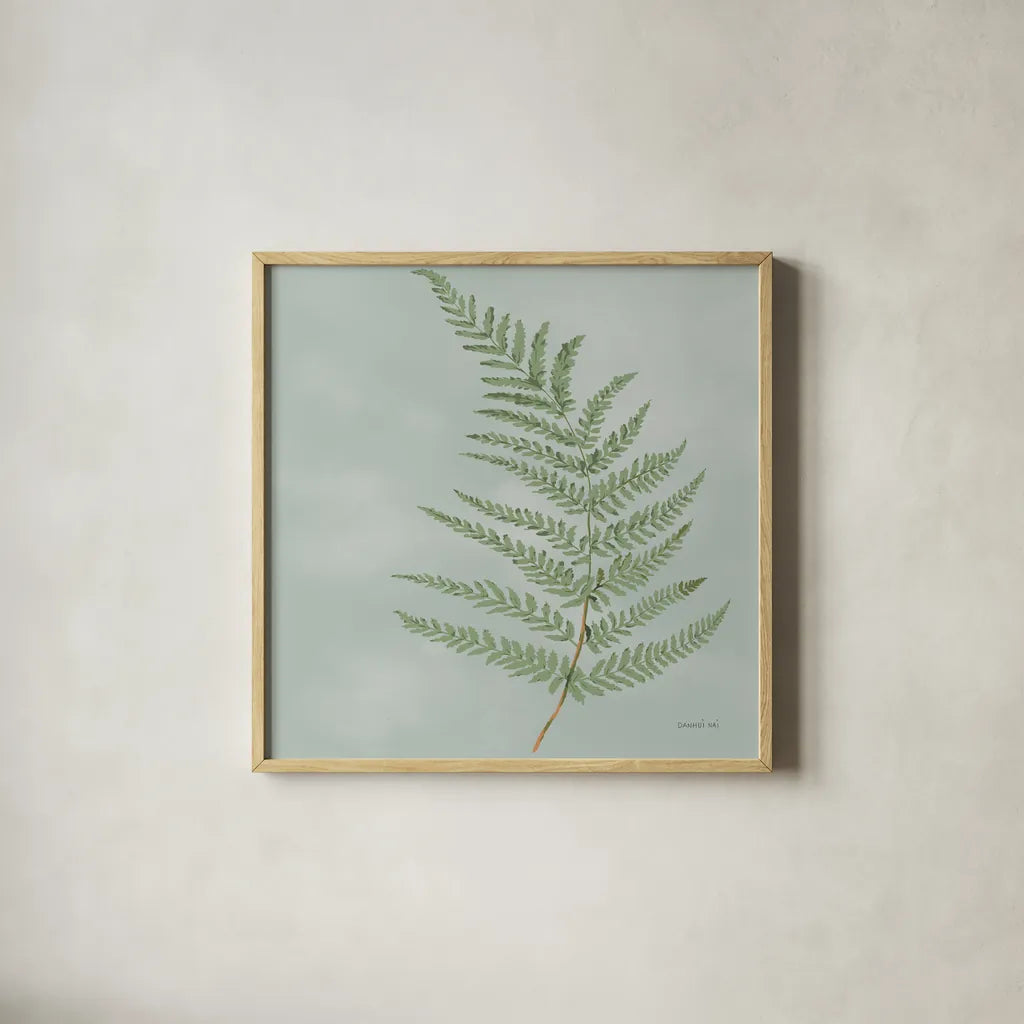 Fern II with Orange by Danhui Nai. Shown in a natural wood glass frame for a timeless modern aesthetic. Available as an archival giclee rolled canvas, fine art paper, or poster print. SKU 86269a.
