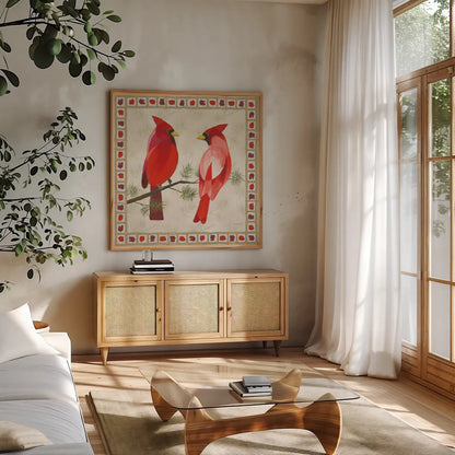 Festive Birds Two Cardinals by Danhui Nai. Shown in a natural wood frame in a cozy modern living room. Available as an archival giclee rolled canvas, fine art paper, or poster print. SKU 21050a.