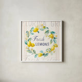 Floursack Lemon V Bright by Danhui Nai. Shown in a crisp white glass frame for a clean and minimalist style. Available as an archival giclee rolled canvas, fine art paper, or poster print. SKU 46701a.