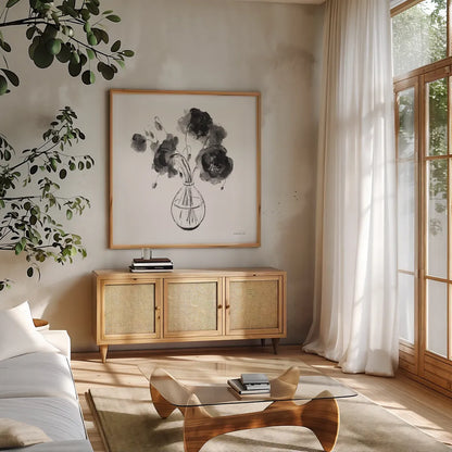 Garden Cuttings II Black by Danhui Nai. Shown in a natural wood frame in a cozy modern living room. Available as an archival giclee rolled canvas, fine art paper, or poster print. SKU 77415a.