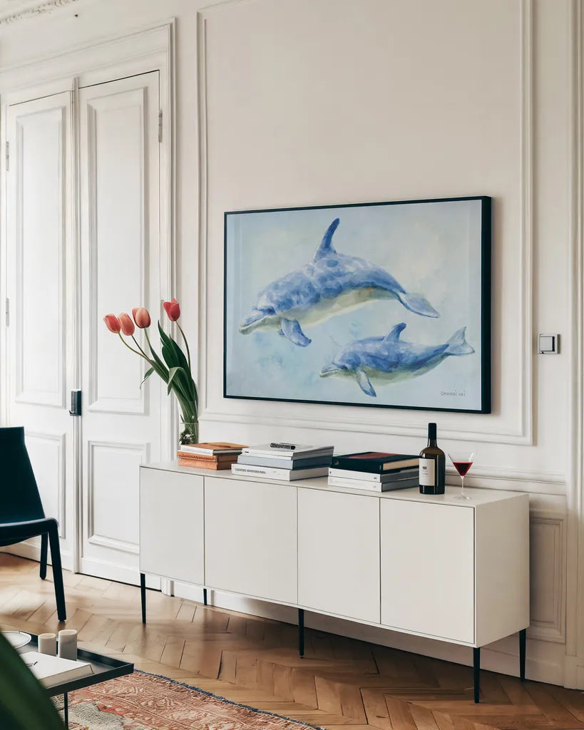 Graceful Dolphins II by Danhui Nai. shown as a framed stretched canvas in a living room above a console. Available as a archival giclee rolled canvas, fine art paper, or poster print. SKU 93409i.