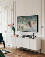 Hot Air Balloons with Pink by Danhui Nai. shown as a framed stretched canvas in a living room above a console. Available as a archival giclee rolled canvas, fine art paper, or poster print. SKU 47867i.