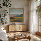 Layered Hills by Danhui Nai. Shown in a natural wood frame in a cozy modern living room. Available as an archival giclee rolled canvas, fine art paper, or poster print. SKU 82551a.