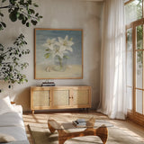 Lilies and Shells by Danhui Nai. Shown in a natural wood frame in a cozy modern living room. Available as an archival giclee rolled canvas, fine art paper, or poster print. SKU 2903a.