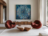 Mandala in Blue II by Danhui Nai. Shown as extra-large giant wall art in a modern living room. Available as an archival giclee rolled canvas, fine art paper, or poster print. SKU 23483a.