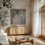 Mandala in Neutral II Sq I by Danhui Nai. Shown in a natural wood frame in a cozy modern living room. Available as an archival giclee rolled canvas, fine art paper, or poster print. SKU 28147a.
