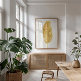 Palms of the Tropics III Gold by Danhui Nai. shown as a print in a natural wood frame in a dining room. Available as a archival giclee rolled canvas, fine art paper, or poster print. SKU 65138h.