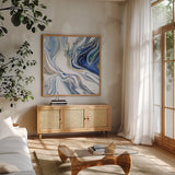 Psychedelic Blue III by Danhui Nai. Shown in a natural wood frame in a cozy modern living room. Available as an archival giclee rolled canvas, fine art paper, or poster print. SKU 84425a.