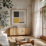 Quadrants Yellow by Danhui Nai. Shown in a natural wood frame in a cozy modern living room. Available as an archival giclee rolled canvas, fine art paper, or poster print. SKU 88106a.