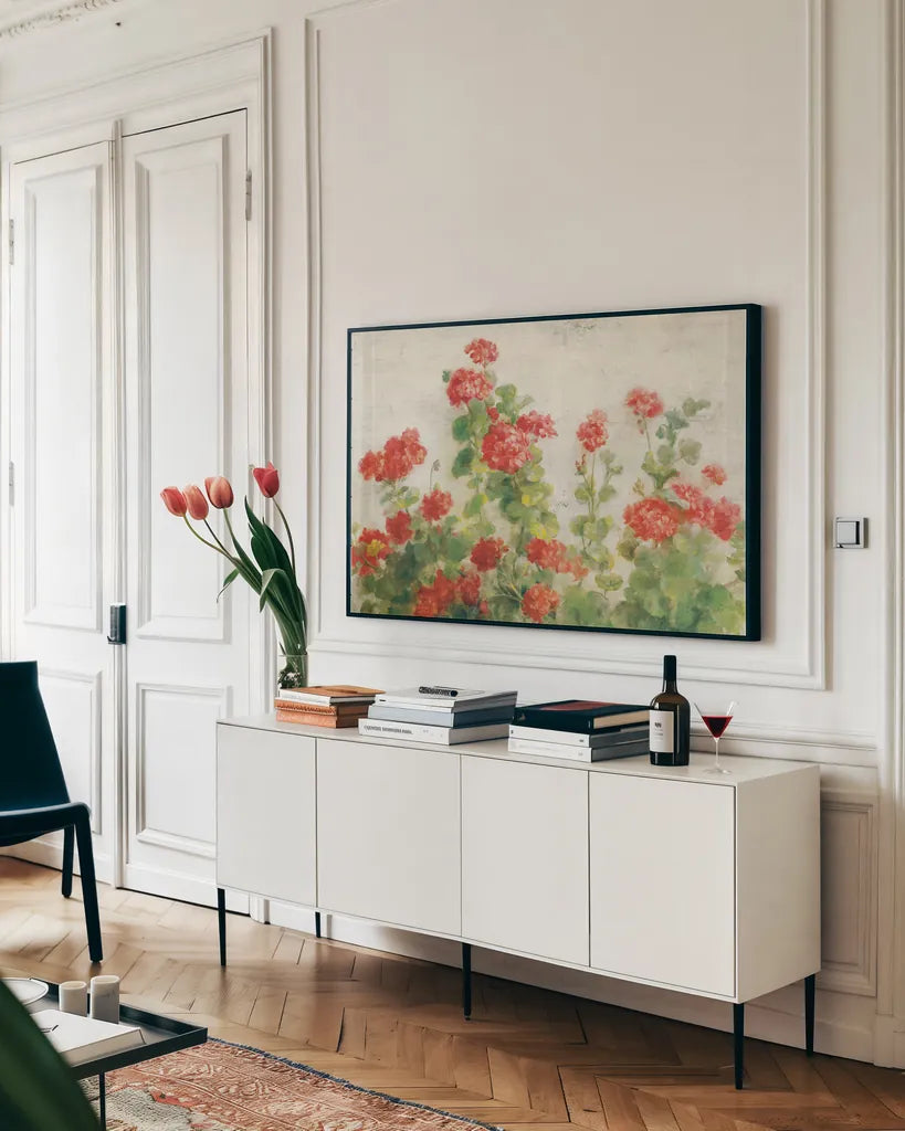 Red Geraniums on White v2 by Danhui Nai. shown as a framed stretched canvas in a living room above a console. Available as a archival giclee rolled canvas, fine art paper, or poster print. SKU 44813i.
