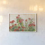 Red Geraniums on White v2 by Danhui Nai. shown as a paper print in a white frame. Available as a archival giclee rolled canvas, fine art paper, or poster print. SKU 44813i.