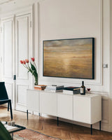 Serene Sea I Gold by Danhui Nai. shown as a framed stretched canvas in a living room above a console. Available as a archival giclee rolled canvas, fine art paper, or poster print. SKU 93186i.