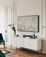 Shades of White Summer by Danhui Nai. shown as a framed stretched canvas in a living room above a console. Available as a archival giclee rolled canvas, fine art paper, or poster print. SKU 83491i.