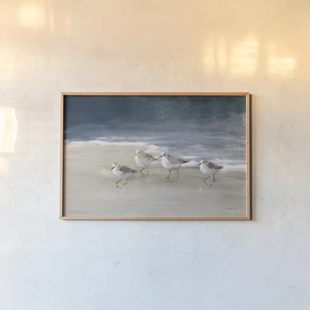 Shorebirds on Sand I Blue by Danhui Nai. shown as a paper print in a natural frame. Available as a archival giclee rolled canvas, fine art paper, or poster print. SKU 88377i.